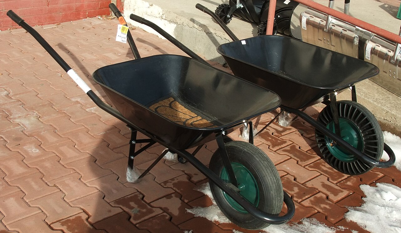 Two garden wheelbarrows side by side, one with a pneumatic tyre and one with a solid puncture-proof wheel
